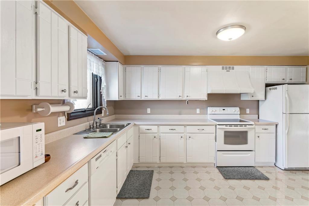 224 County Line Road Bridgeville, PA 15017 - Photo 12 of 25 a kitchen with a sink stove and cabinets