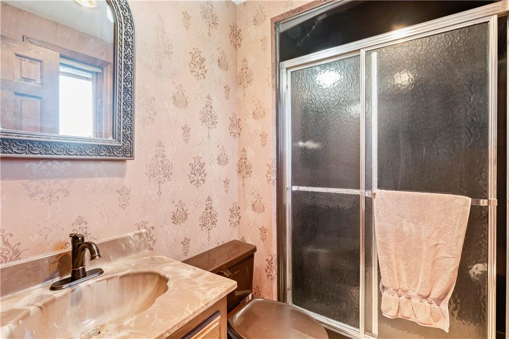224 County Line Road Bridgeville, PA 15017 - Photo 15 of 25 a bathroom with a sink and a mirror