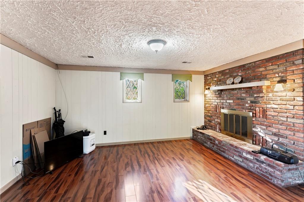 224 County Line Road Bridgeville, PA 15017 - Photo 19 of 25 wooden floor in an empty room with a fireplace