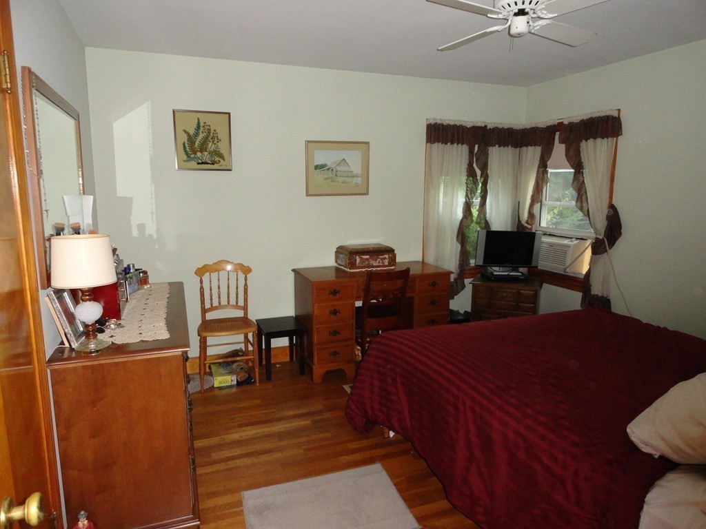 24 Warren Road Townsend, MA 01469 - Photo 9 of 15 a bed room with a bed window and chair