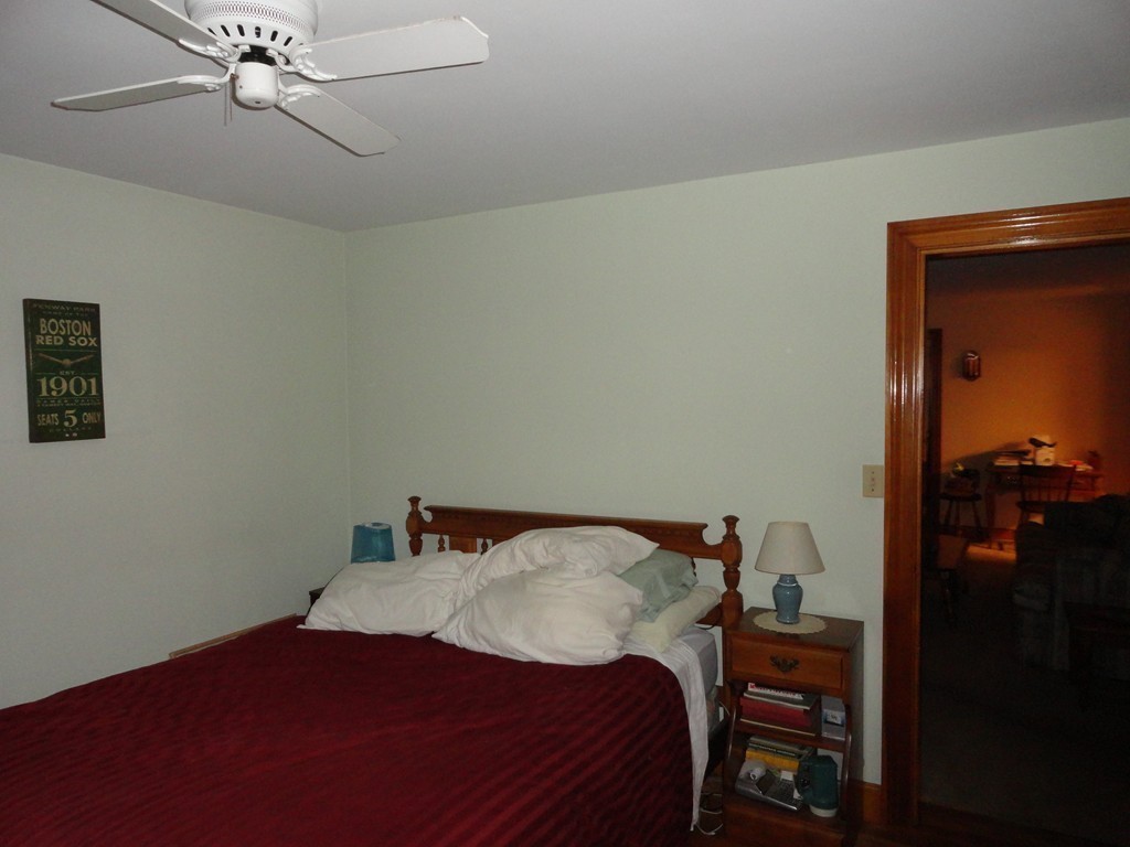 24 Warren Road Townsend, MA 01469 - Photo 10 of 15 a bedroom with a bed and a chandelier