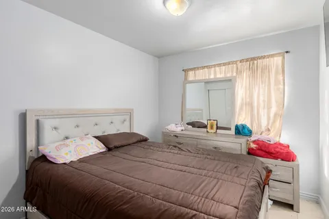 a bedroom with a bed and closet