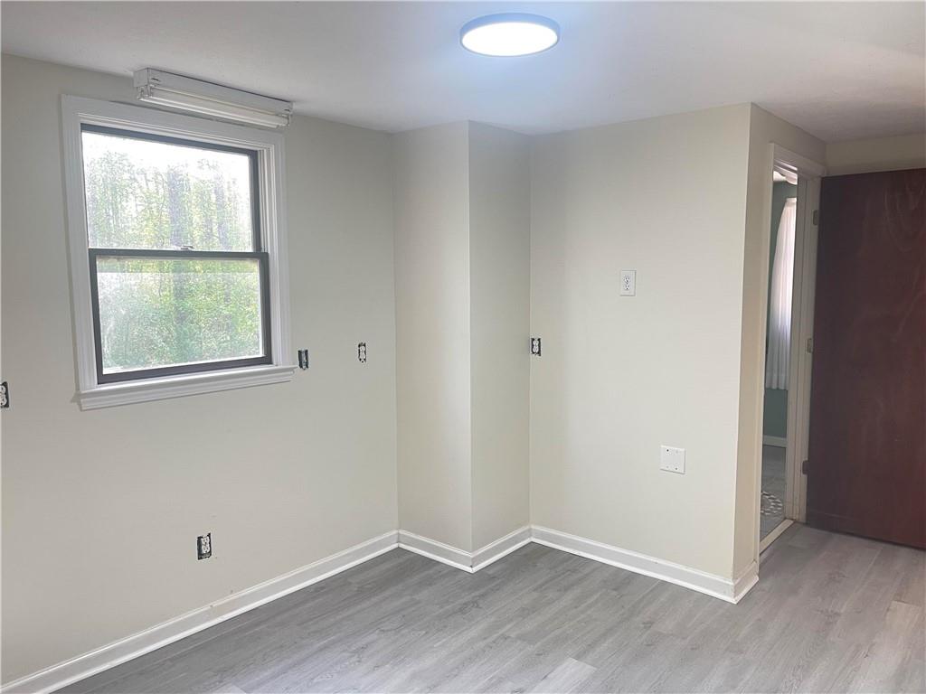12005 A Hutchesons Ferry Road Palmetto, GA 30268 - Photo 12 of 53 an empty room with wooden floor and windows