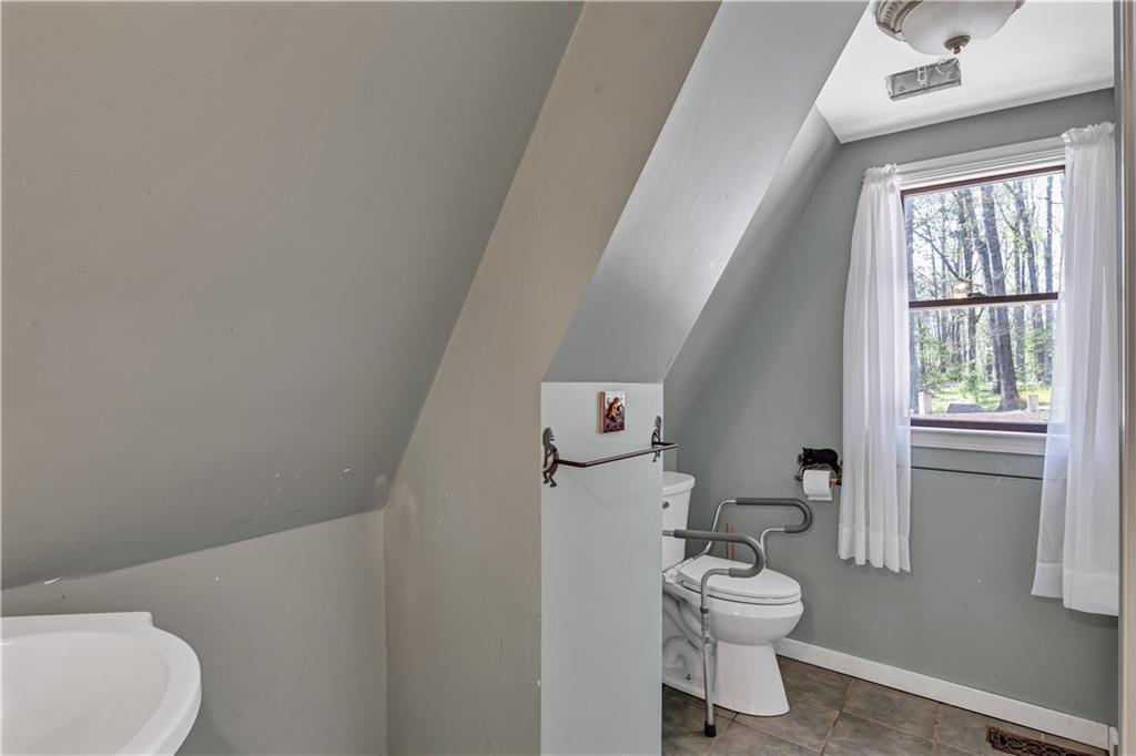 12005 A Hutchesons Ferry Road Palmetto, GA 30268 - Photo 16 of 53 a bathroom with a toilet and a shower curtain
