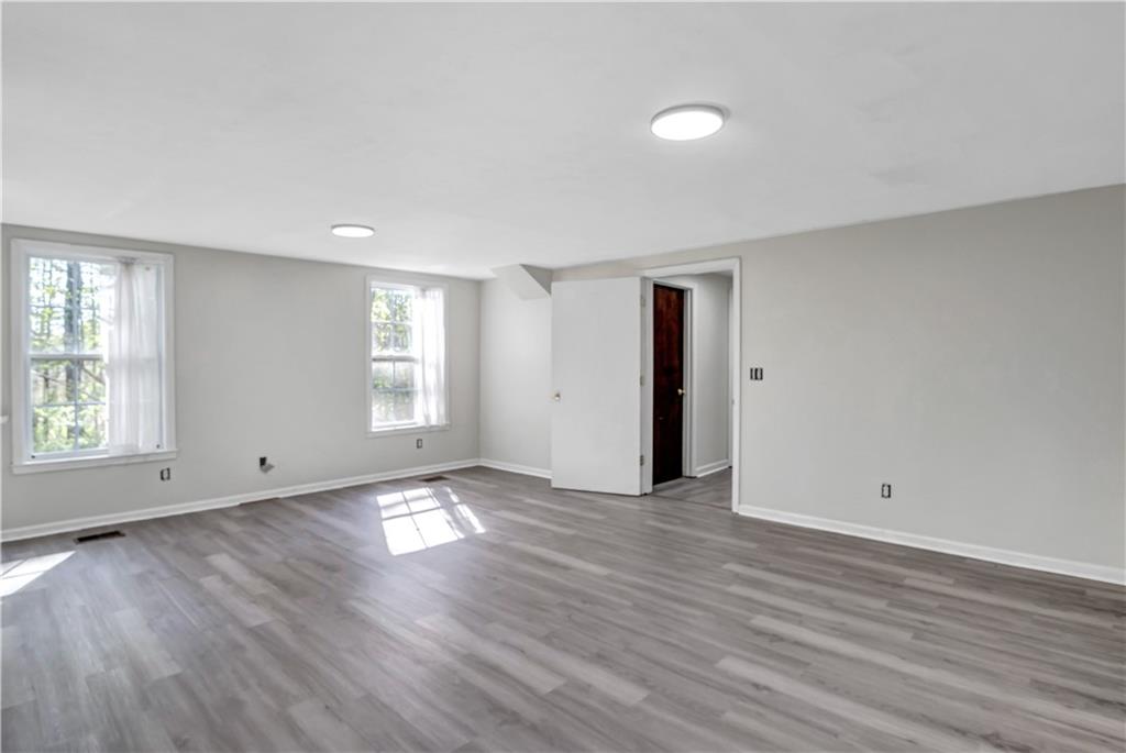 12005 A Hutchesons Ferry Road Palmetto, GA 30268 - Photo 23 of 53 an empty room with wooden floor and windows