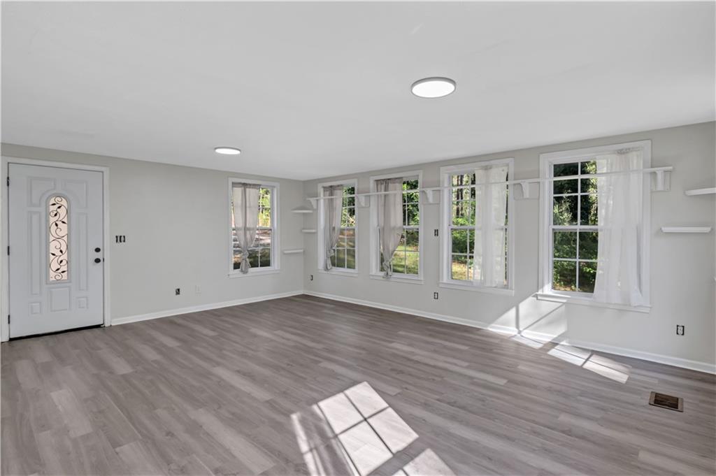 12005 A Hutchesons Ferry Road Palmetto, GA 30268 - Photo 24 of 53 a view of an empty room with wooden floor and a window