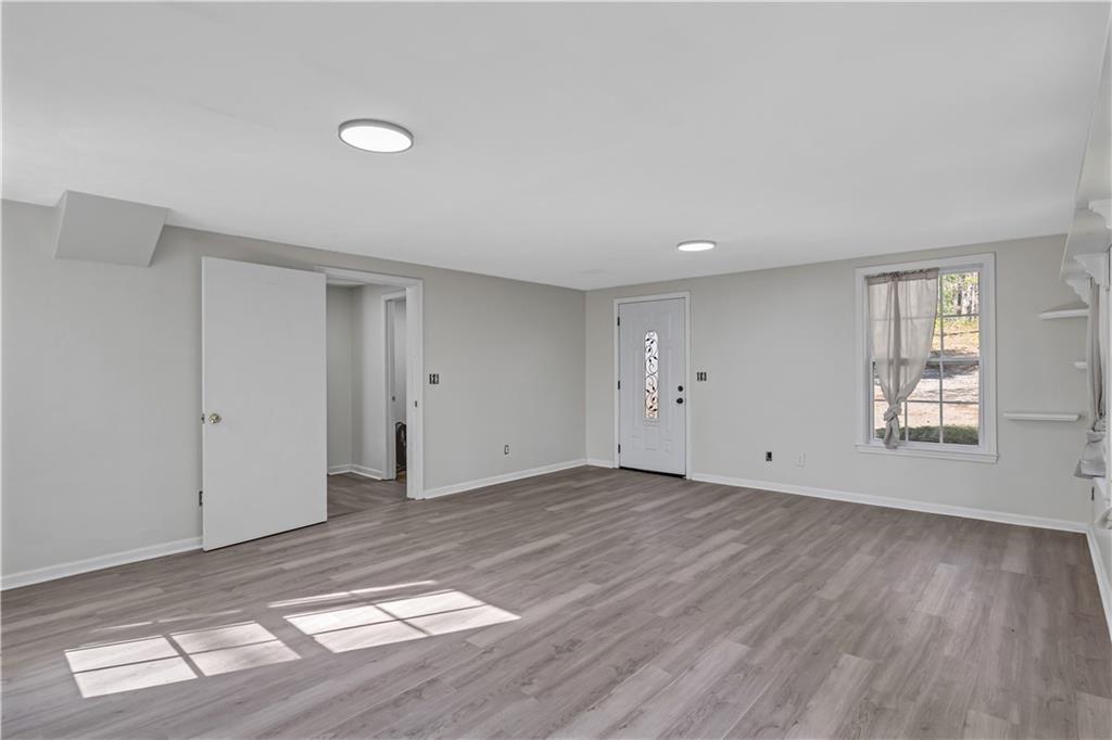 12005 A Hutchesons Ferry Road Palmetto, GA 30268 - Photo 25 of 53 a view of an empty room with wooden floor and a window