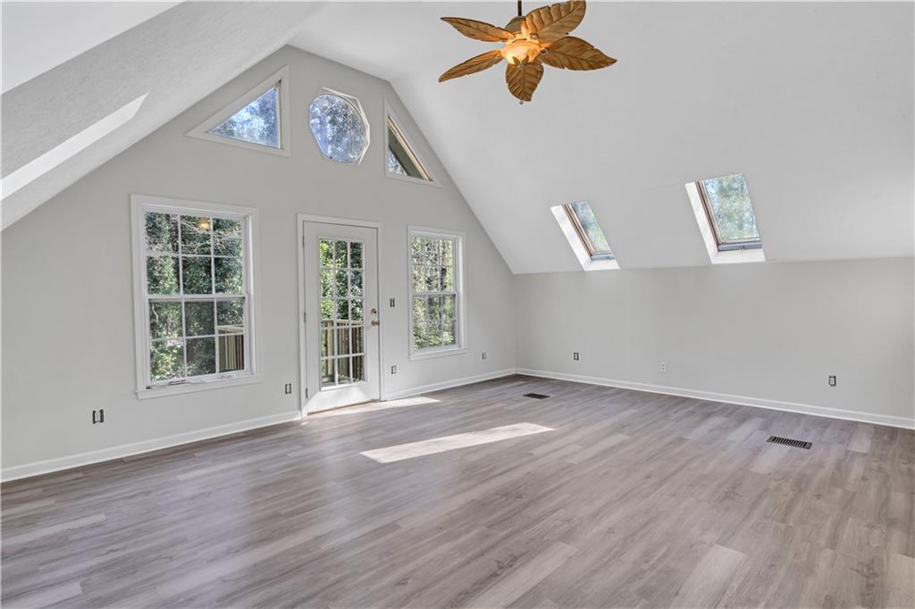 12005 A Hutchesons Ferry Road Palmetto, GA 30268 - Photo 29 of 53 a view of an empty room with a window and wooden floor