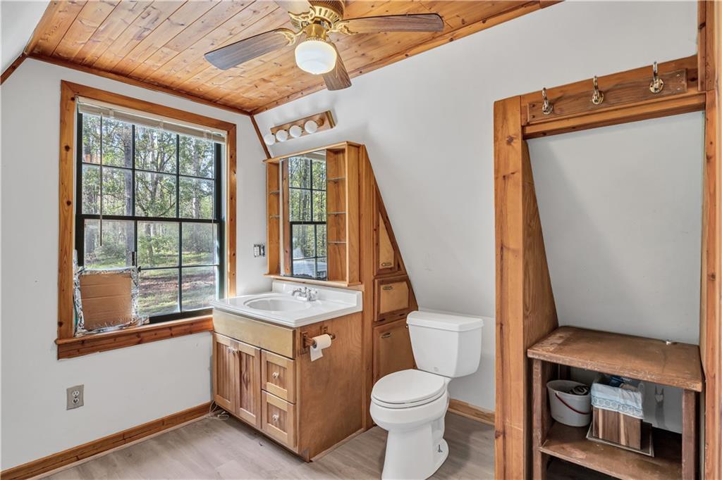 12005 A Hutchesons Ferry Road Palmetto, GA 30268 - Photo 31 of 53 a bathroom with a sink a toilet and a mirror