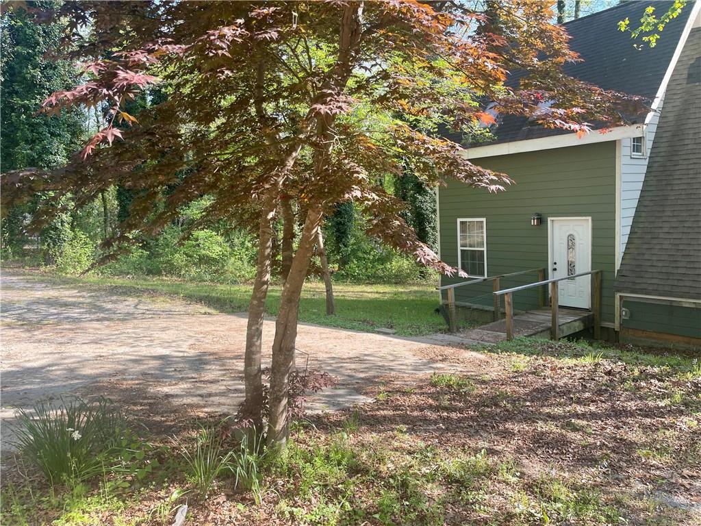 12005 A Hutchesons Ferry Road Palmetto, GA 30268 - Photo 47 of 53 a view of a house with backyard and a tree