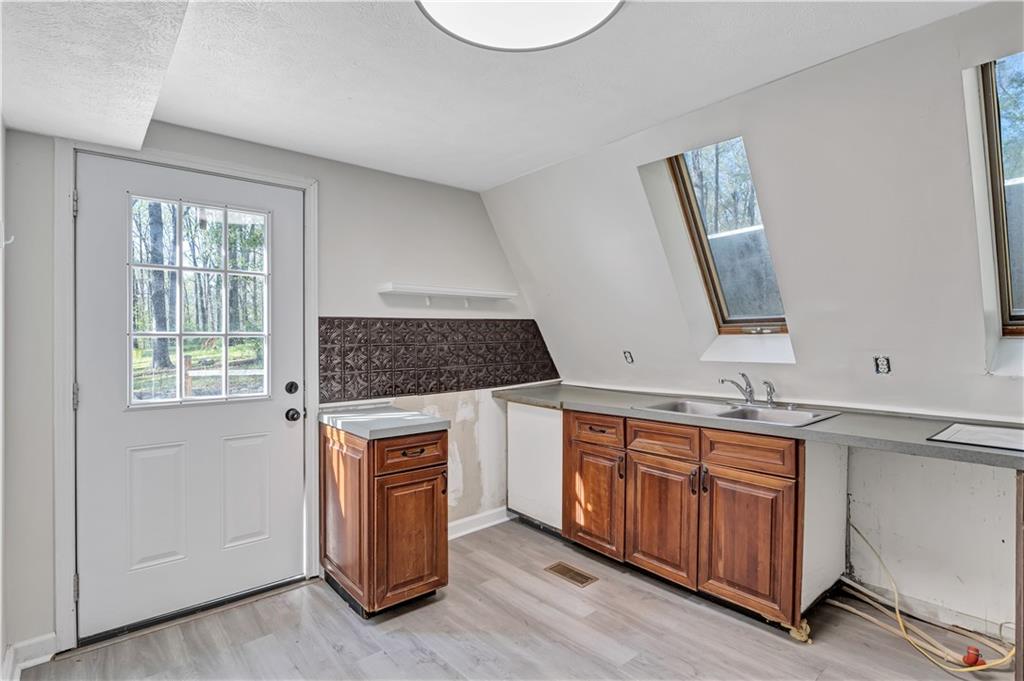 12005 A Hutchesons Ferry Road Palmetto, GA 30268 - Photo 8 of 53 a kitchen with a sink stove and cabinets