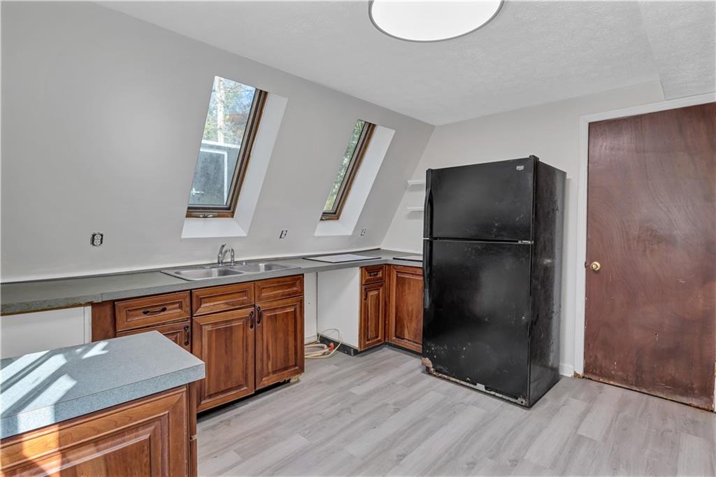 12005 A Hutchesons Ferry Road Palmetto, GA 30268 - Photo 9 of 53 a kitchen with stainless steel appliances granite countertop a refrigerator a sink and a stove with wooden floor