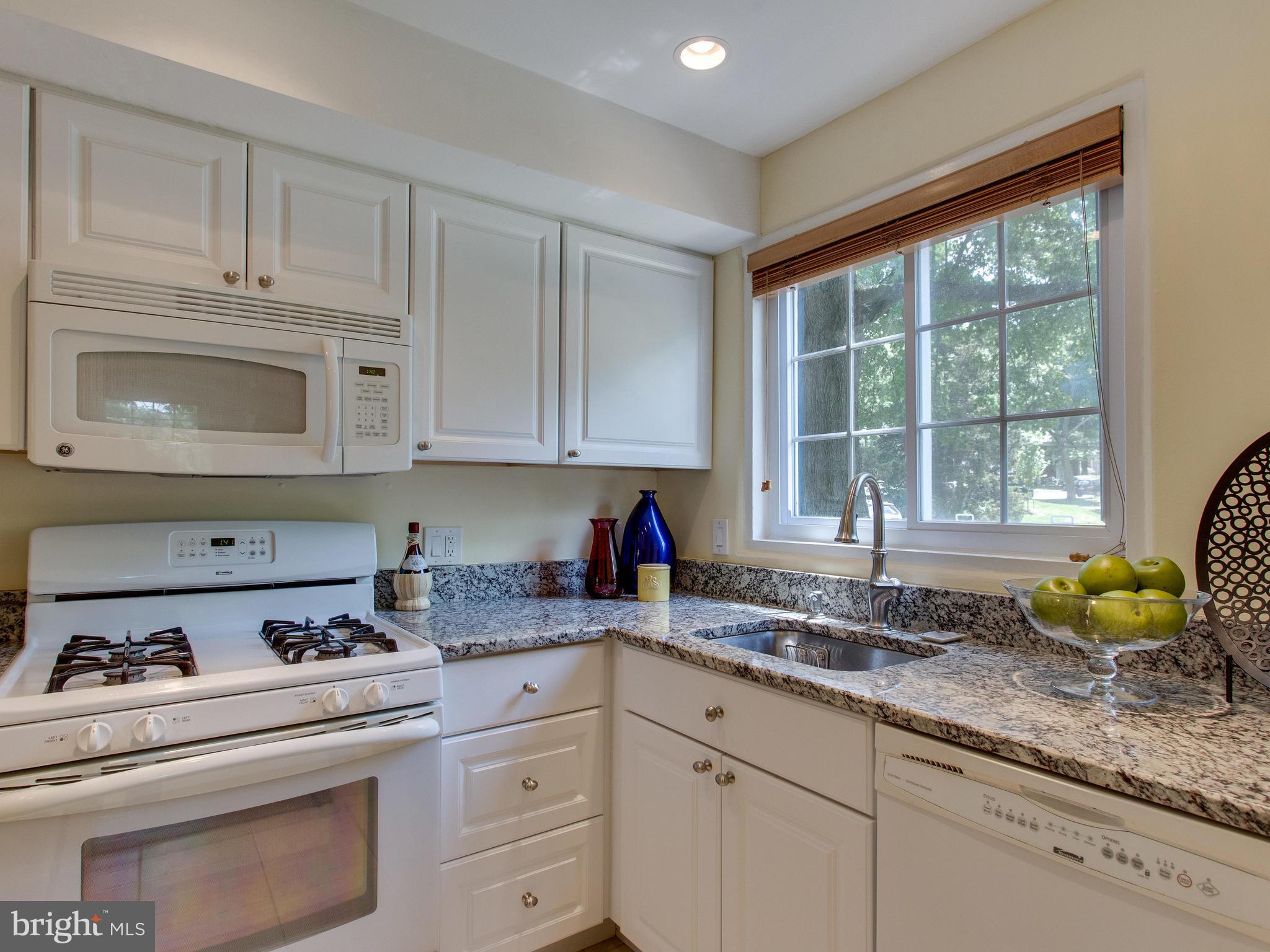 3753 Gunston Road Alexandria, VA 22302 - Photo 3 of 17 a kitchen with granite countertop a sink white cabinets and window