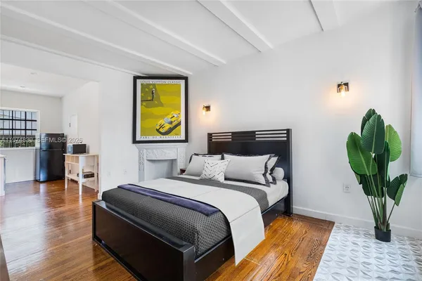 a bedroom with bed and a potted plant