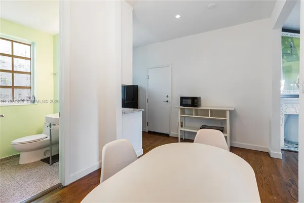 a view of a workspace with furniture and wooden floor