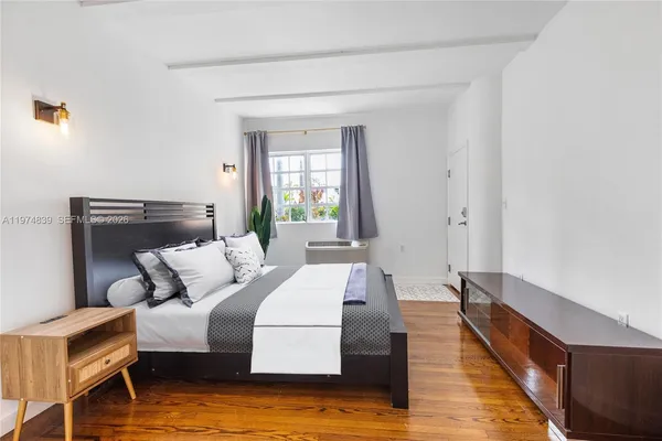 a bedroom with a bed and window