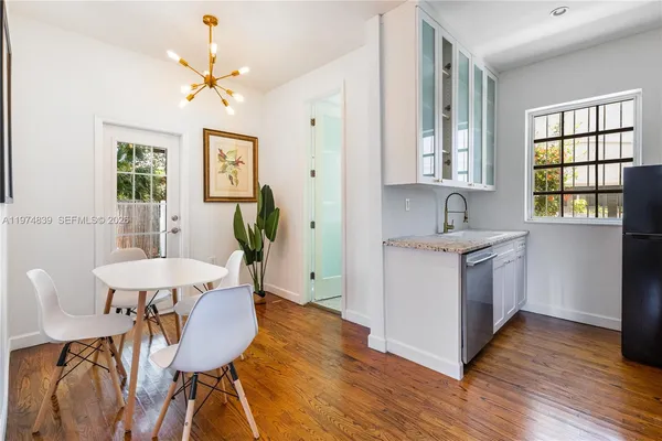 a kitchen that has a table and chairs in it