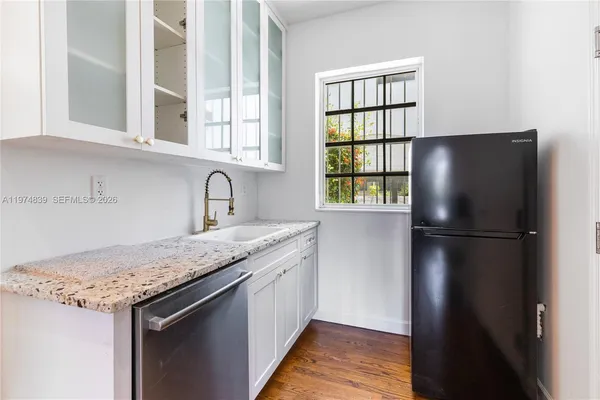 a kitchen with a refrigerator and a sink