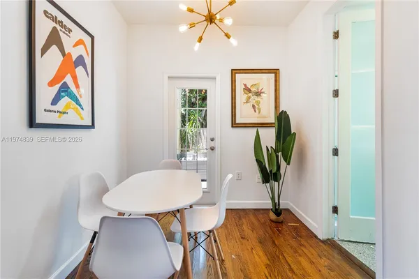 a view of a dining room with furniture wooden floor and a chandelier