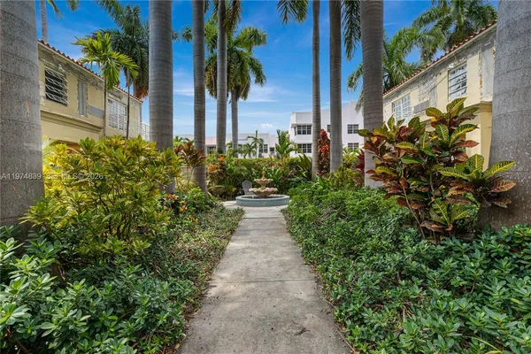 a view of a pathway with flower plants