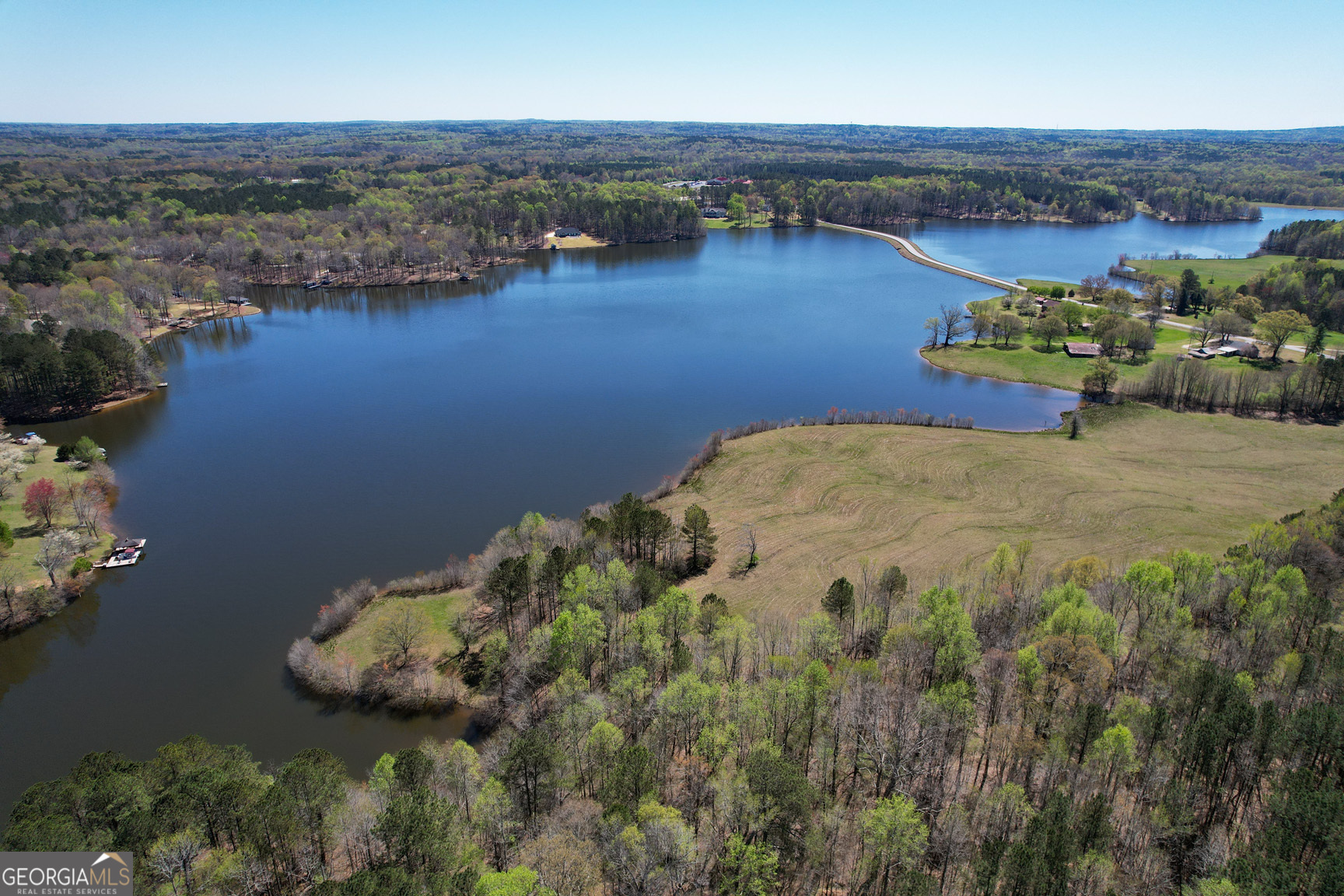 an aerial view of a house with a lake view