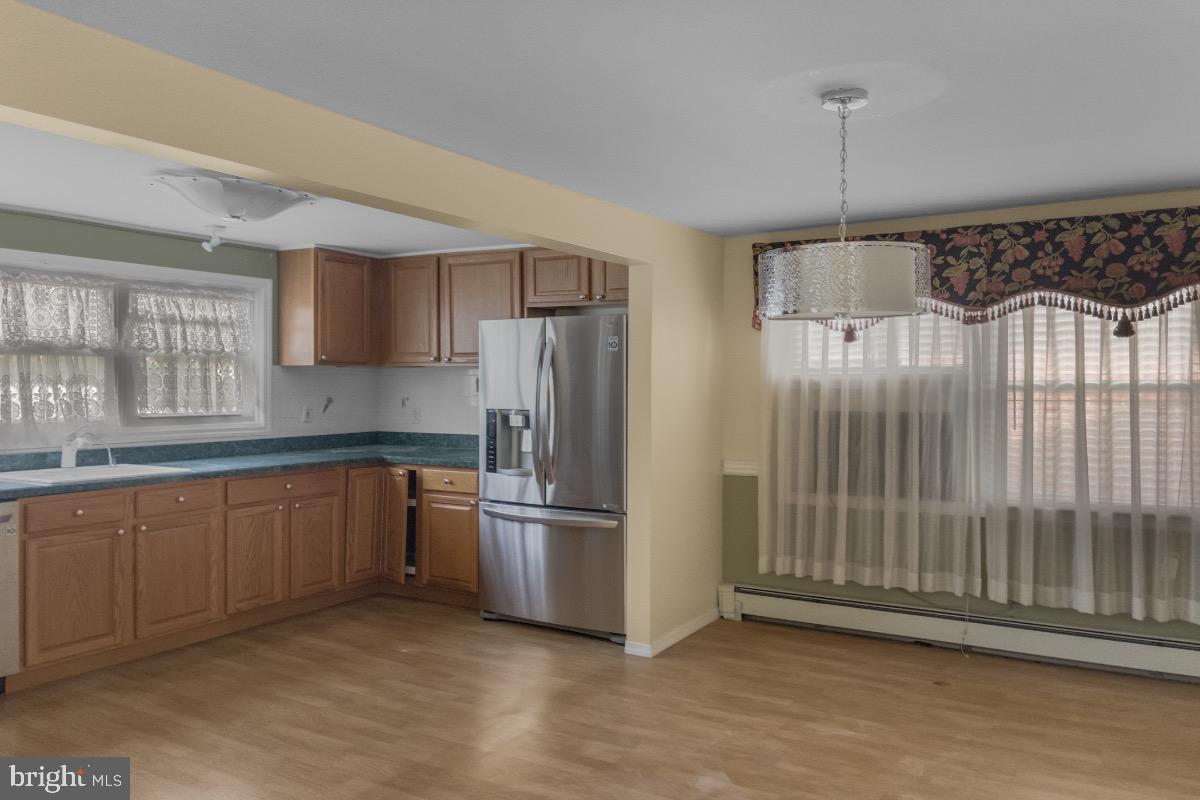 155 Locust Avenue Hamilton, NJ 08610 - Photo 7 of 25 a kitchen with granite countertop a refrigerator and a sink