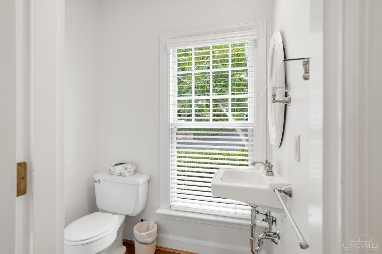 2780 Walsh Road Cincinnati, OH 45208 - Photo 20 of 77 This convenient first-floor powder room (one of two on the first floor) is thoughtfully positioned off the main living areas. Featuring a pedestal sink, warm tones and a window that fills the space with natural light, this secondary powder room offers a comfortable and convenient option for everyday use.