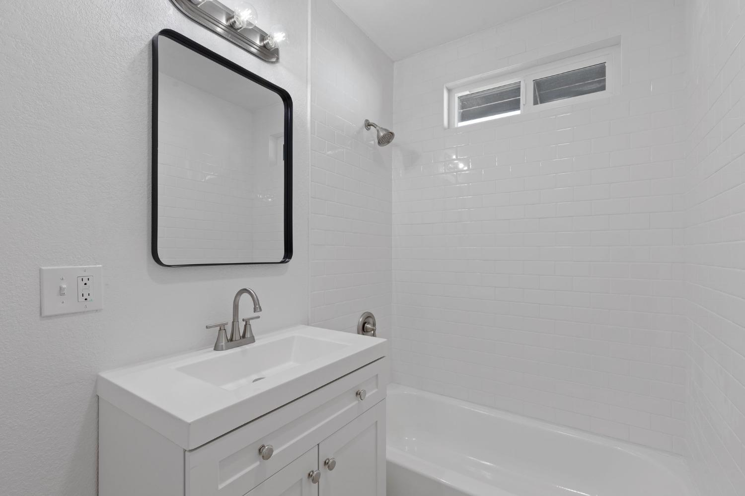 3321 East Montecito Avenue Fresno, CA 93702 - Photo 13 of 22 a bathroom with a toilet sink and mirror