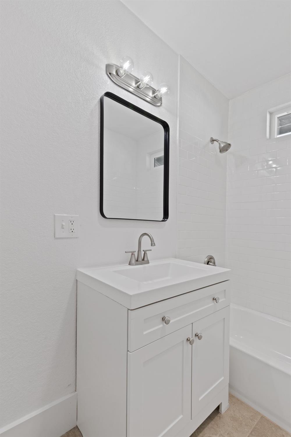 3321 East Montecito Avenue Fresno, CA 93702 - Photo 14 of 22 a bathroom with a sink vanity and mirror