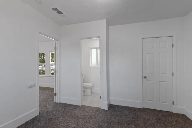 an empty room with closet area
