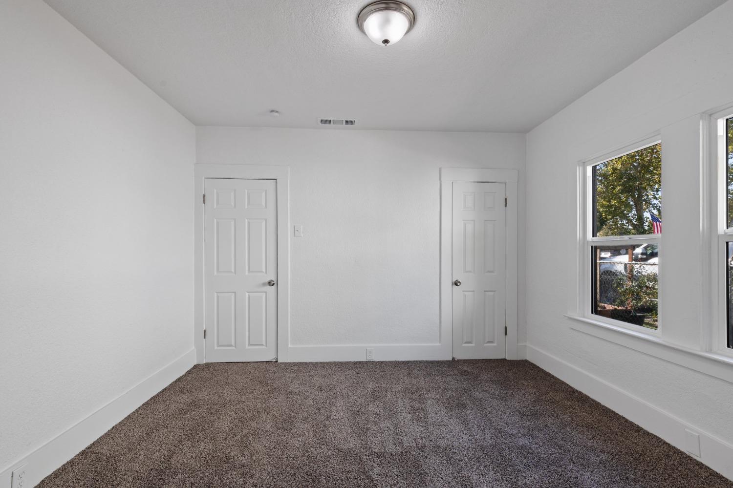 3321 East Montecito Avenue Fresno, CA 93702 - Photo 19 of 22 a view of an empty room with a window