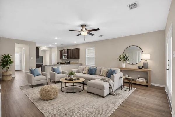 a living room with furniture a rug and a chandelier