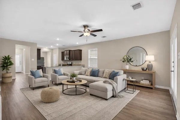 a living room with furniture a rug and a chandelier