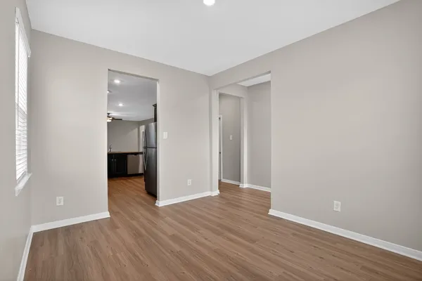 a view of a hallway with wooden floor