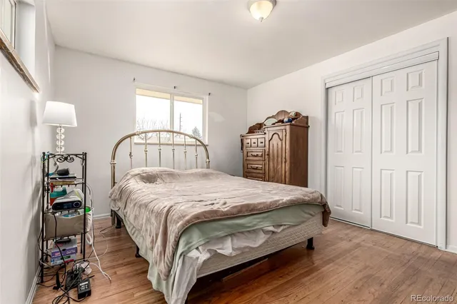 a bed sitting in a bedroom next to a window