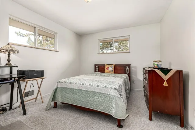 a bedroom with a bed and chair