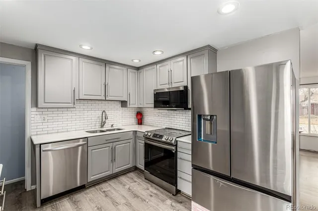 a kitchen with refrigerator a sink and cabinets
