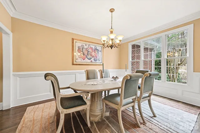 a view of a dining room with furniture wooden floor and chandelier