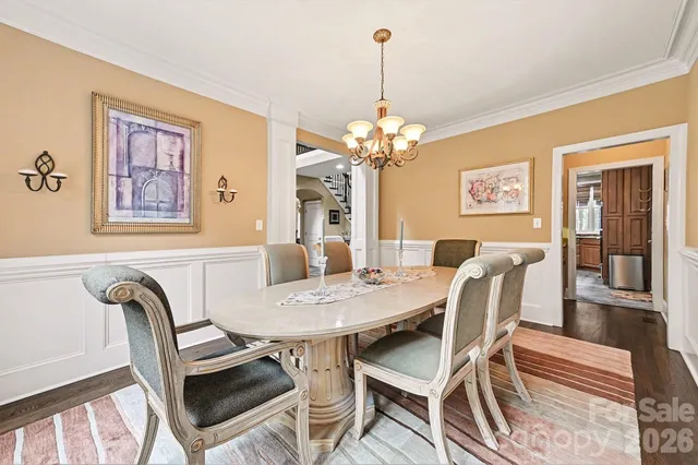 a view of a dining room with furniture wooden floor and a chandelier