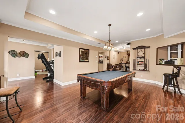 a view of a room with furniture and wooden floor