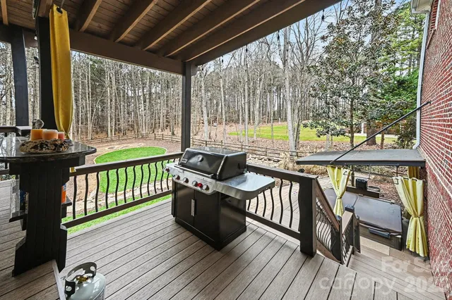 a view of a patio with a table chairs and wooden floor