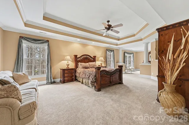 a bedroom with furniture and a large window