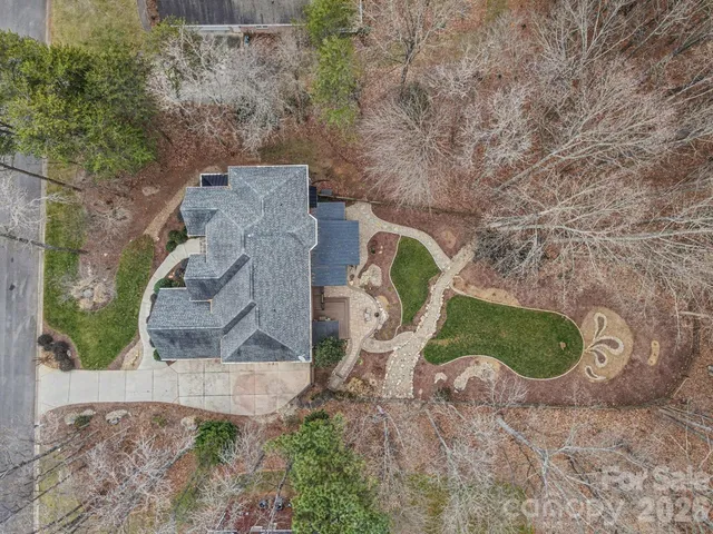 an aerial view of a house with a yard and fence