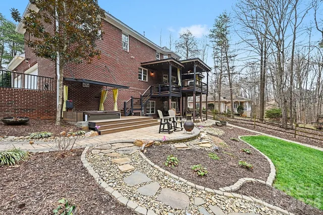 a view of a house with a yard patio and fire pit