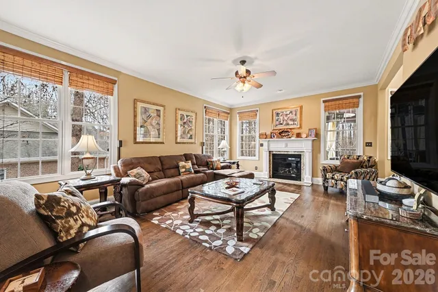 a living room with furniture fireplace and a large window
