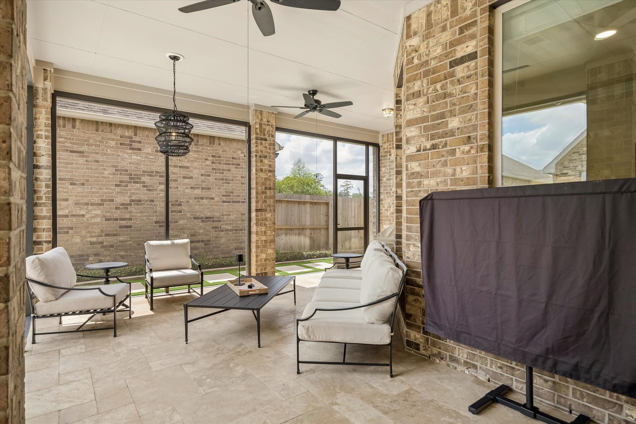 7418 Kearney Hill Lane Spring, TX 77389 - Photo 26 of 35 The oversized covered patio features a screened porch, limestone decking, high ceilings, and is equipped with two fans for air circulation.