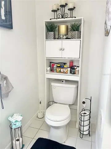 a living room with furniture floor to ceiling window and wooden floor