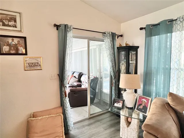 a bedroom with furniture and a large window