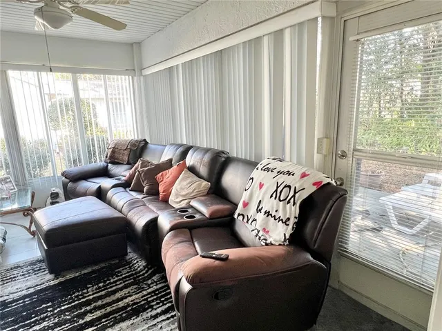 a view of a patio with couches table and chairs and potted plants