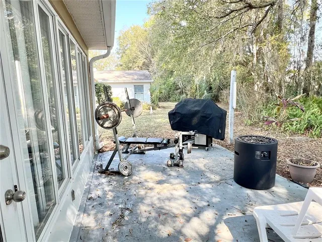 a view of a house with backyard and sitting area